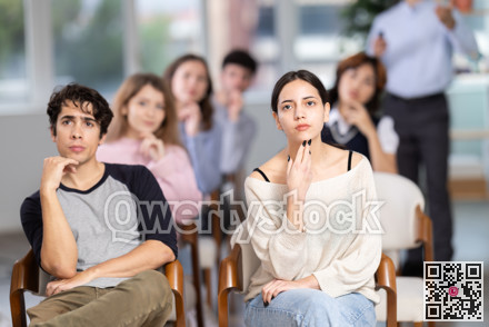 Young people are listening to lecture in auditorium