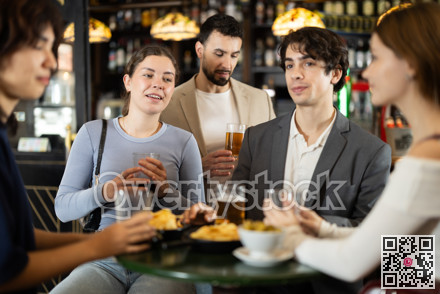 Group of friends happily having time at bar