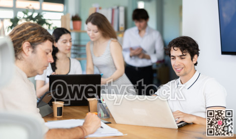 Several managers work together in a modern office. Well-coordinated management team