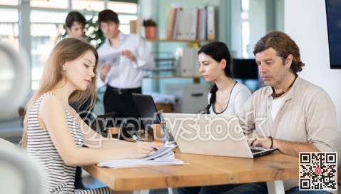 Several managers work together in a modern office. Well-coordinated management team