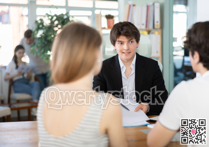 Bank manager discusses loan terms with married couple