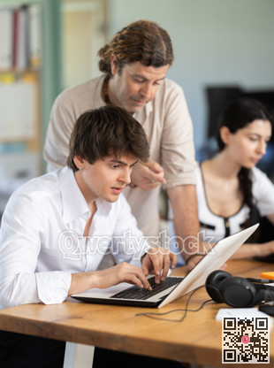 Man helps guy complete task on laptop
