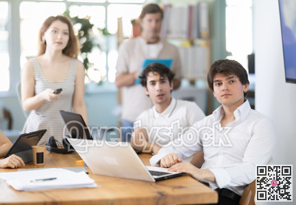 Male and female colleagues watching presentation in office