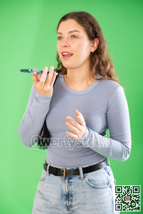 Girl records voice message using voice recorder or communicates by voice messages in messengers