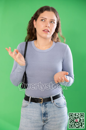 Thoughtful girl expresses bewilderment or forgetfulness on green background