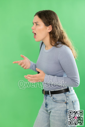 Aggressive woman expresses negative emotions by screaming and waving her arms. Chroma key compositing