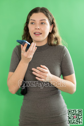 Girl records voice message using voice recorder or communicates by voice messages in messengers