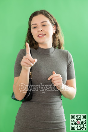 Young woman moves her finger across virtual screen