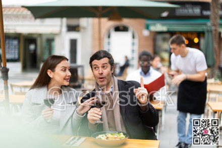 Girl in cafe sits near male companion, has nice conversation and discusses news of day