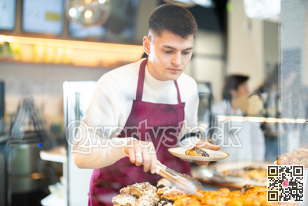 Guy salesperson and girl works in cafeteria bakery shop