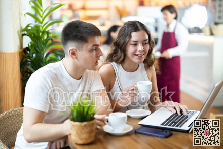 Couple man and woman with laptop drinking coffee and talking