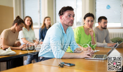 Man using laptop during lesson in university