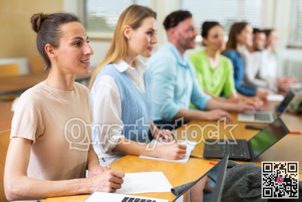 Group of students attentively listening to lecture in university classroom