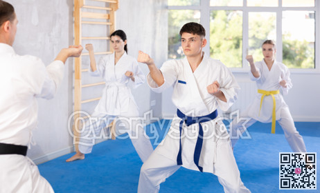 Group of people training karate technique