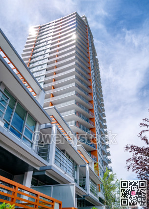 Brand new high-rise building on blue and white sky background