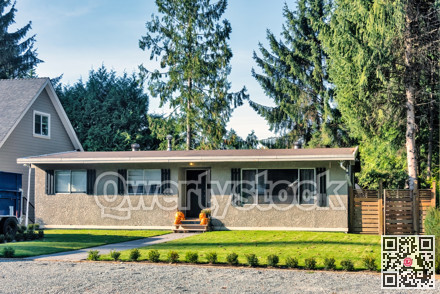 Modest residential house decorated with orange pumpkins