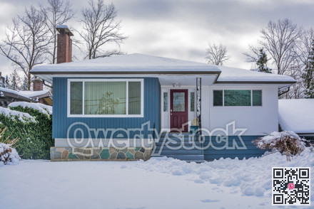 Family house with front yard in snow.
