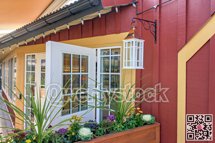 Entrance of a street cafe decorated with flowers