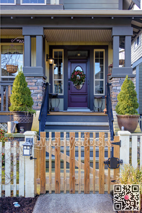 Entrance of luxury residential house with unpainted wooden gate in front