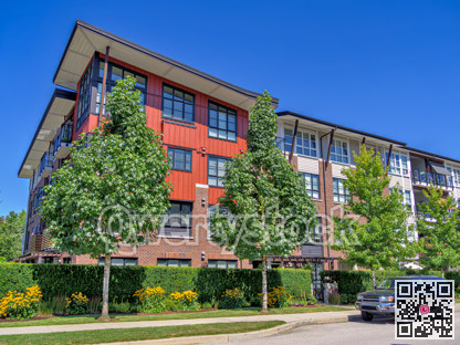 New residential apartment building with a truck parked on the roadside.