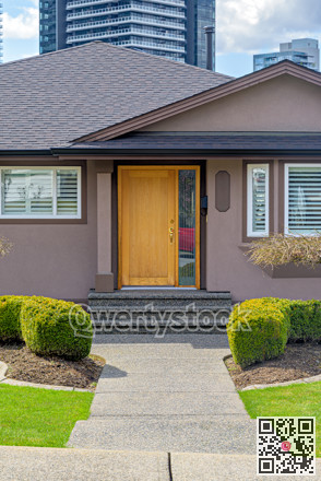 Neat entrance of a family house on residential high-rise buildings background
