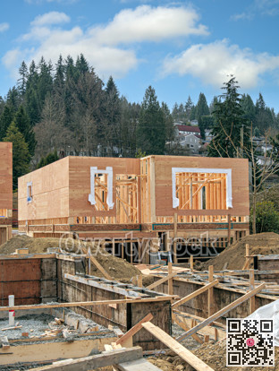 Wooden frame of new house with concrete filled fundation in front