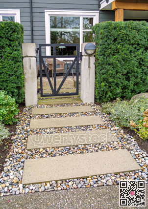Ground level gated entrance of residential apartment on cloudy autumn day
