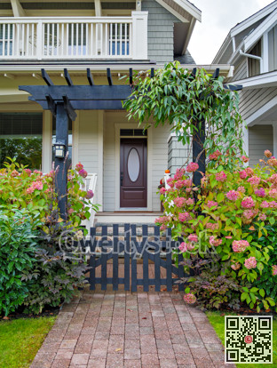 Entrance of luxury residential house with unpainted wooden gate in front