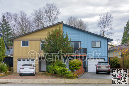 Duplex residential house with cars parked in front on autumn season in British Columbia
