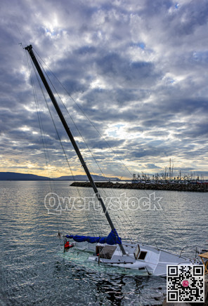 White yacht sinking in Pacific Ocean bay