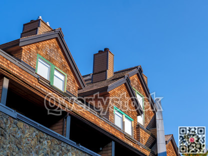 Residential condo with attic bedrooms on blue sky background