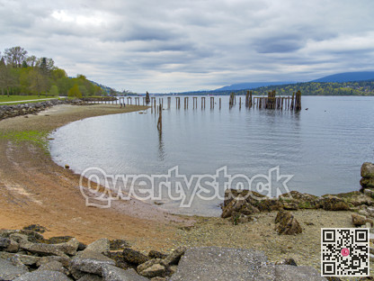 Round inlet and waterfront park with old wooden pier in the water