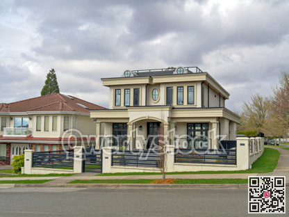 The street corner with residential houses on overcast sky background
