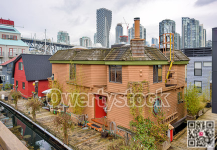 Row of houses on the water with view at downtown of Vancouver, Canada
