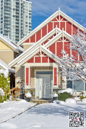 Modern high-rise and private residential house in snow on winter season