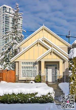 Modern high-rise and private residential house in snow on winter season