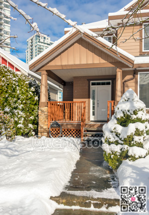 Modern high-rise and private residential house in snow on winter season