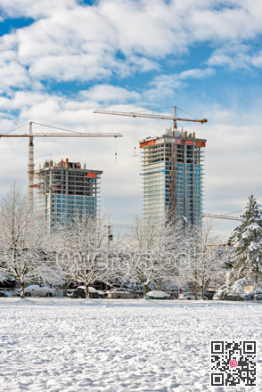 New high-rise residential buildings under construction on bright winter day