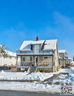Small old family residential house on sunny winter day in Canada