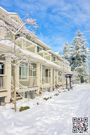 Row of residential townhouses on bright winter day in Vancouver, BC