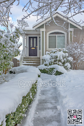 Cleaned pathway to the family residential house over front yard in snow