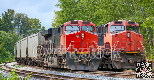 Two red locomotives are waiting for the semaphore signal