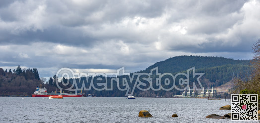 Overview of Pacific Ocean bay near Vancouver with production plant on the shore