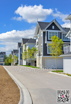 A perfect neighborhood. Brand new townhouses district on blue sky and clouds background