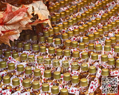 Rows of Maple leaf syrup bottles with decorative maple leaves on top