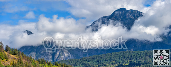 Mountain landscape view with clouds below the mountain's tops