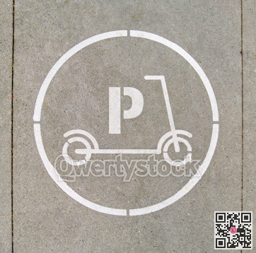 Electric scooter parking stall sign on concrete pavement surface