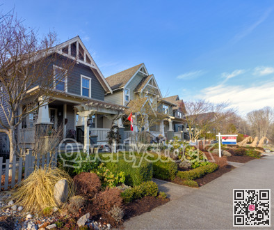 Row of residential houses with one house for sale on winter season in Canada